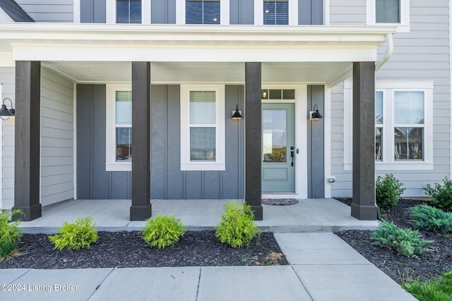 doorway to property featuring a porch and board and batten siding