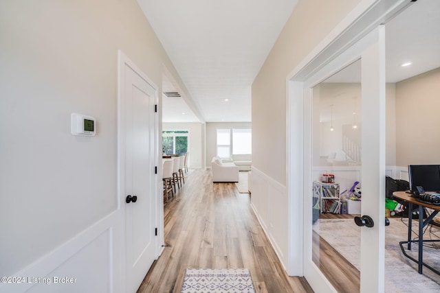 hall with recessed lighting, light wood-type flooring, and visible vents