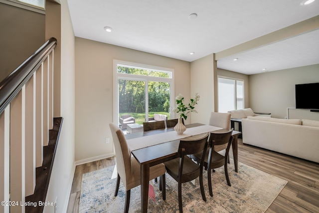 dining space with recessed lighting, stairway, baseboards, and wood finished floors