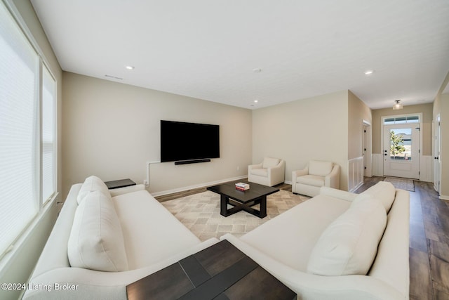 living room featuring wood finished floors, recessed lighting, visible vents, and baseboards