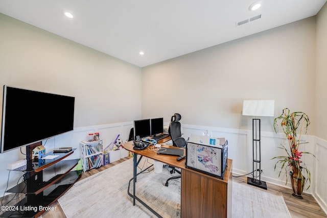 office with visible vents, recessed lighting, wood finished floors, and a wainscoted wall