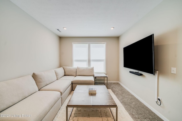 carpeted living area with baseboards and visible vents