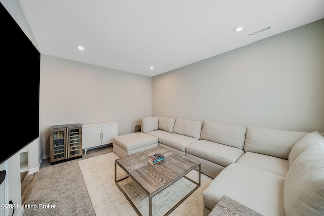 living room with recessed lighting, visible vents, and beverage cooler