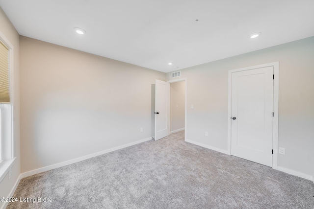 unfurnished bedroom with recessed lighting, carpet flooring, baseboards, and visible vents