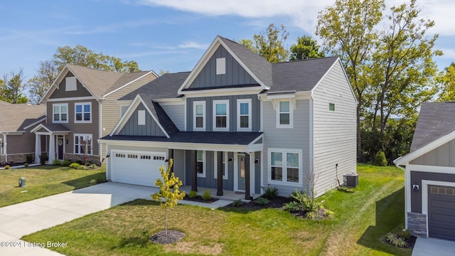craftsman-style home with a front yard, central air condition unit, concrete driveway, and board and batten siding