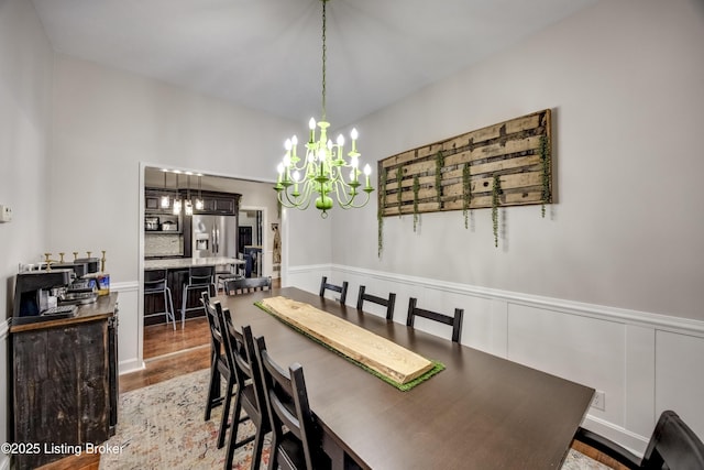 3140 Yorkshire Dr, Bardstown, KY 40004 - dining area featuring a notable chandelier, wood finished floors, a decorative wall, and wainscoting