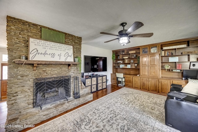 3140 Yorkshire Dr, Bardstown, KY 40004 - living room featuring a ceiling fan, dark wood-style floors, a fireplace, and a textured ceiling