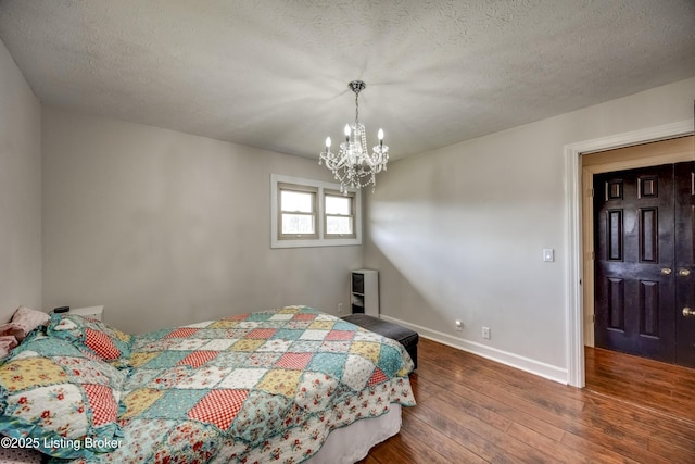 3140 Yorkshire Dr, Bardstown, KY 40004 - bedroom featuring baseboards, a textured ceiling, a notable chandelier, and wood-type flooring