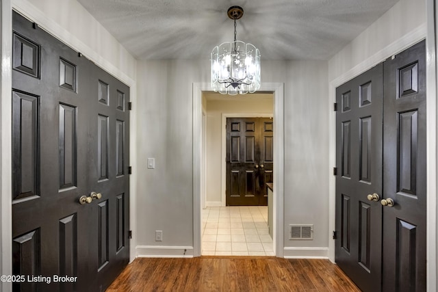 3140 Yorkshire Dr, Bardstown, KY 40004 - foyer featuring baseboards, visible vents, an inviting chandelier, and wood finished floors