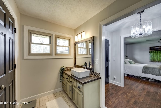 3140 Yorkshire Dr, Bardstown, KY 40004 - bathroom featuring baseboards, a chandelier, a textured ceiling, connected bathroom, and wood finished floors