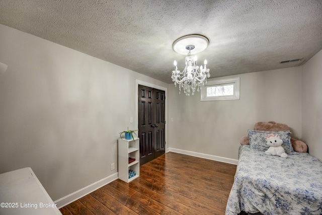 3140 Yorkshire Dr, Bardstown, KY 40004 - bedroom featuring wood-type flooring, an inviting chandelier, baseboards, a textured ceiling, and visible vents