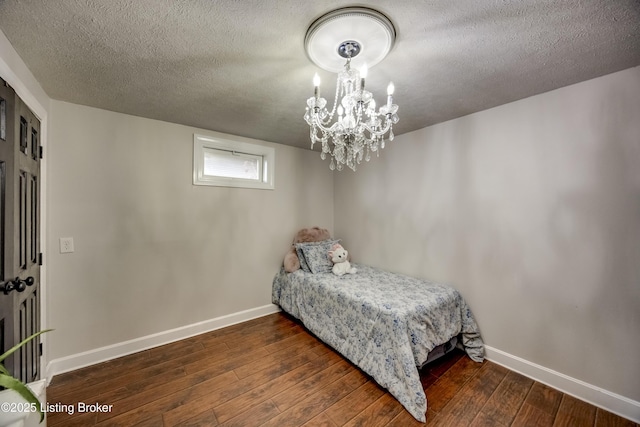 3140 Yorkshire Dr, Bardstown, KY 40004 - bedroom with wood-type flooring, an inviting chandelier, baseboards, and a textured ceiling
