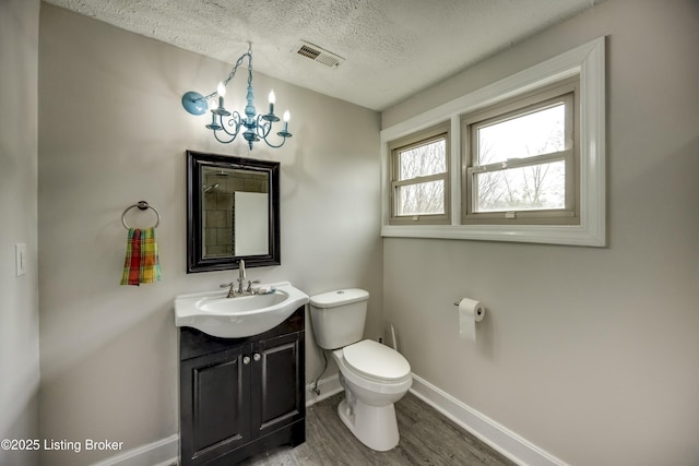 3140 Yorkshire Dr, Bardstown, KY 40004 - bathroom featuring a textured ceiling, visible vents, toilet, wood finished floors, and a notable chandelier