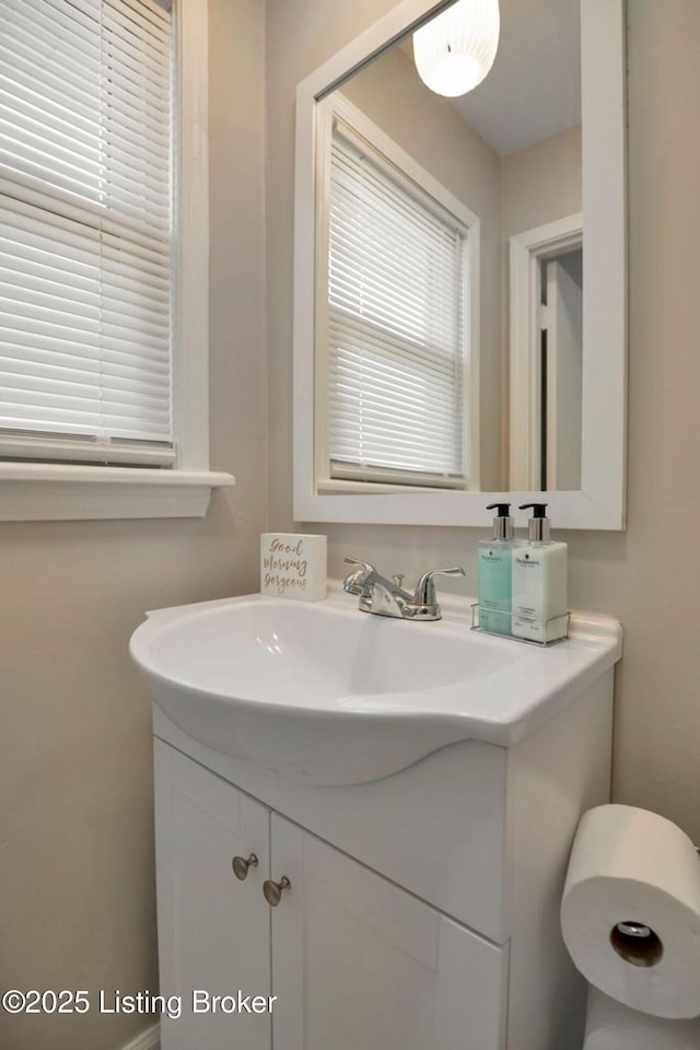 bathroom with a healthy amount of sunlight and vanity