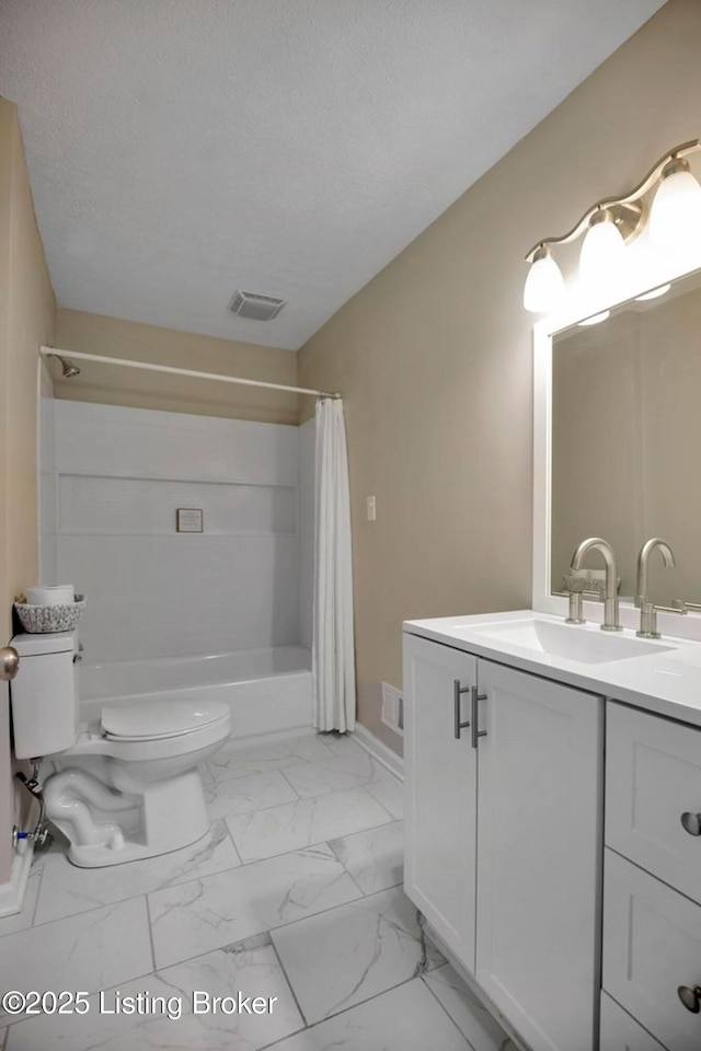 bathroom with vanity, shower / bath combo with shower curtain, a textured ceiling, toilet, and marble finish floor