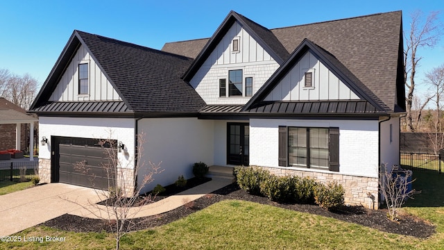 modern farmhouse featuring metal roof, stone siding, board and batten siding, and a standing seam roof