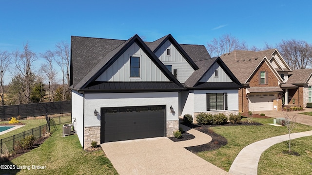 view of front facade featuring fence, board and batten siding, an attached garage, and a standing seam roof