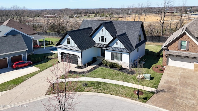 view of front of property with a front yard, driveway, roof with shingles, stone siding, and board and batten siding