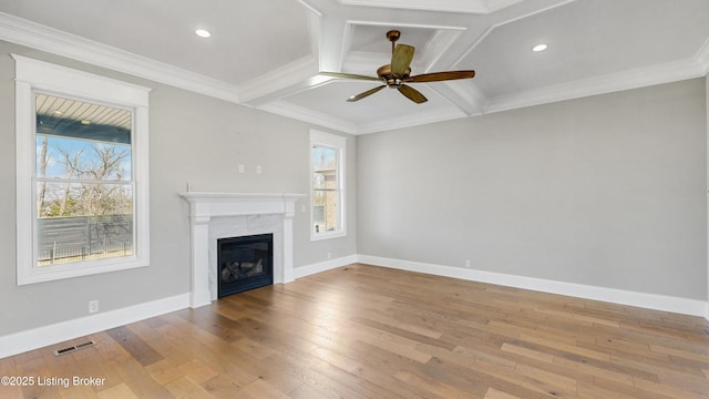 unfurnished living room featuring ceiling fan, baseboards, and hardwood / wood-style floors