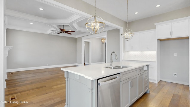 kitchen featuring coffered ceiling, a sink, dishwasher, ceiling fan with notable chandelier, and backsplash
