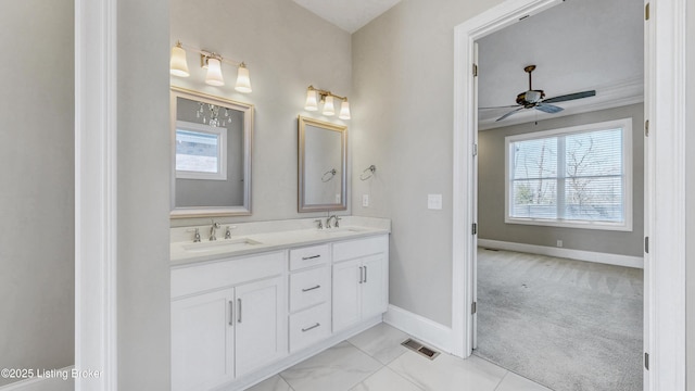 bathroom with ceiling fan, a wealth of natural light, and a sink
