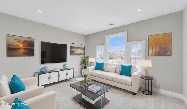 carpeted living room with recessed lighting, visible vents, and baseboards
