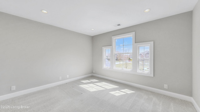 unfurnished room featuring visible vents, recessed lighting, baseboards, and carpet floors