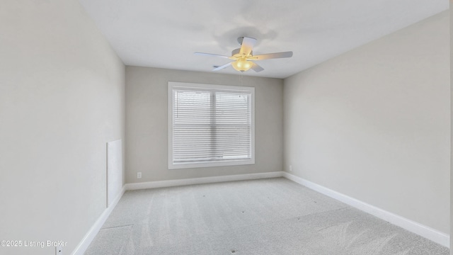 spare room with baseboards, carpet, and a ceiling fan