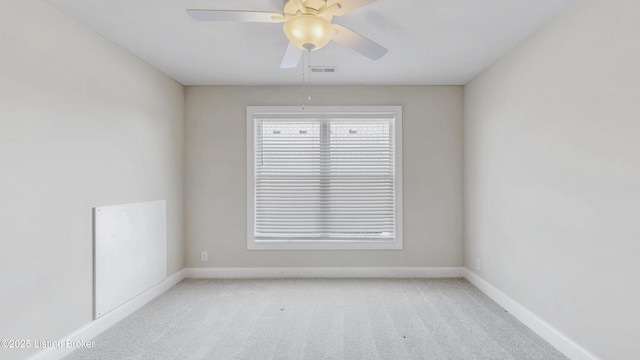 unfurnished room featuring light carpet, visible vents, ceiling fan, and baseboards