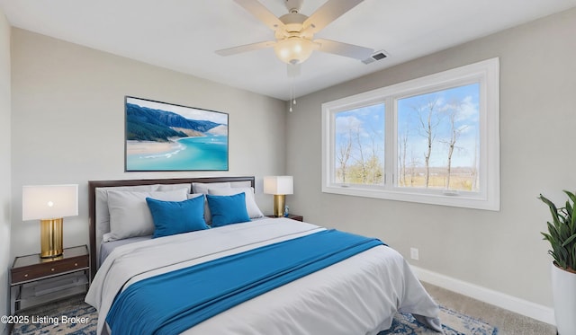bedroom with carpet flooring, baseboards, visible vents, and ceiling fan