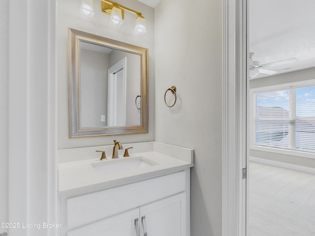 bathroom with baseboards, ceiling fan, and vanity