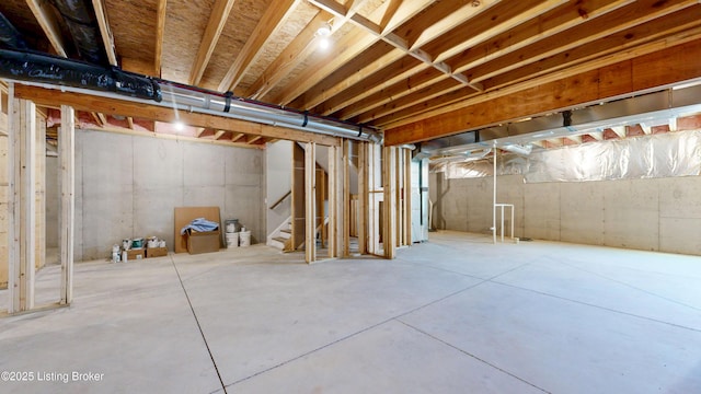 unfinished basement featuring stairway