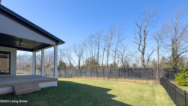 view of yard with a patio area, a ceiling fan, and a fenced backyard