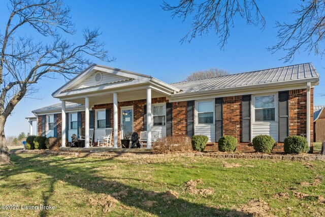 268 Cobb Rd, Eminence, KY 40019 - neoclassical / greek revival house featuring a front yard, a porch, brick siding, and metal roof
