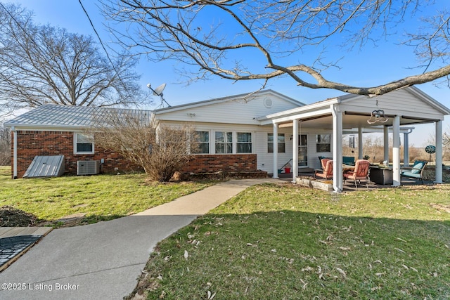 268 Cobb Rd, Eminence, KY 40019 - back of house with central air condition unit, a patio, brick siding, and a lawn