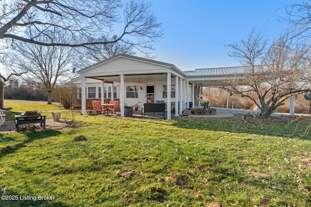268 Cobb Rd, Eminence, KY 40019 - back of property with metal roof, an outdoor living space, ceiling fan, a yard, and a patio area