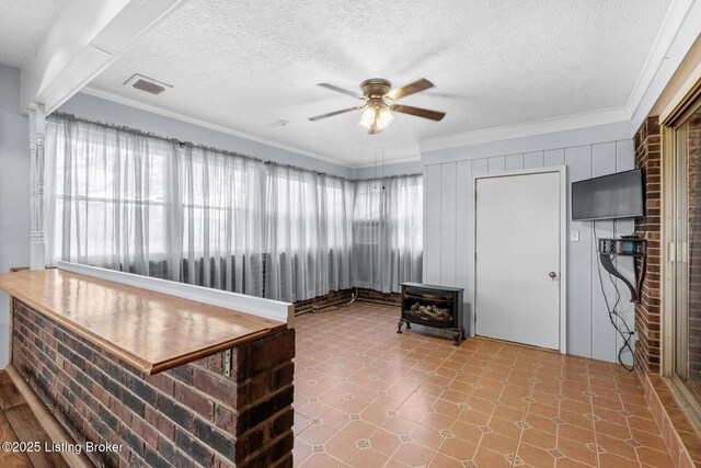 268 Cobb Rd, Eminence, KY 40019 - office area featuring a wood stove, a textured ceiling, ornamental molding, tile patterned floors, and a ceiling fan