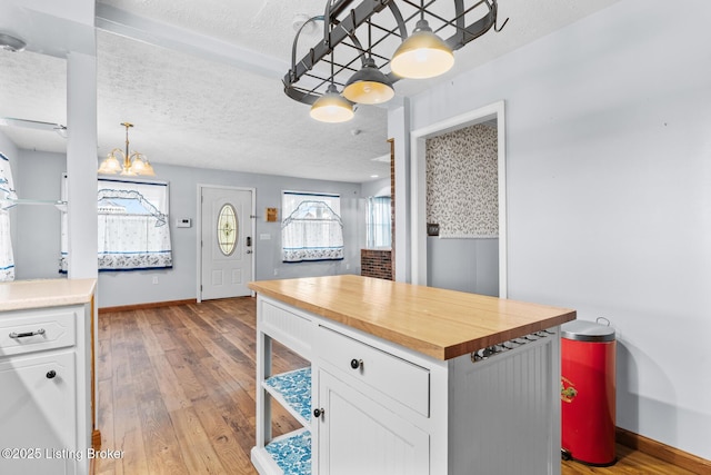 268 Cobb Rd, Eminence, KY 40019 - kitchen with wooden counters, baseboards, hardwood / wood-style floors, and white cabinets