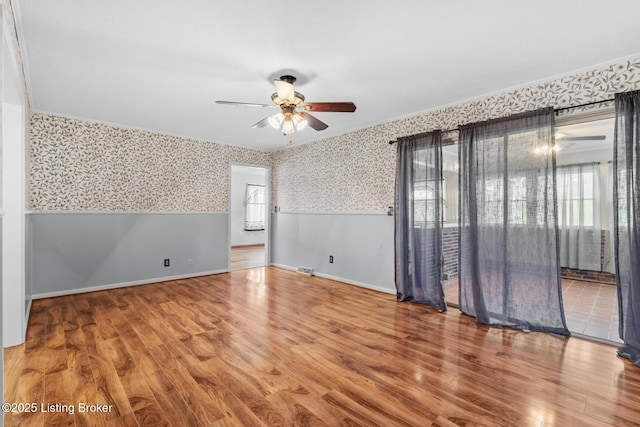 268 Cobb Rd, Eminence, KY 40019 - unfurnished room with baseboards, a ceiling fan, wallpapered walls, and wood finished floors
