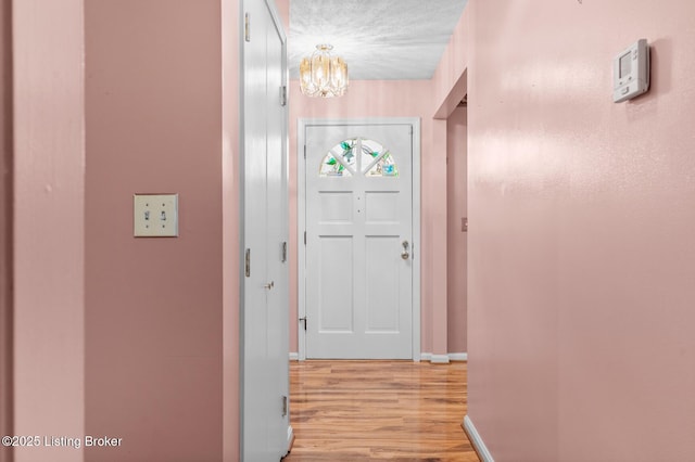 268 Cobb Rd, Eminence, KY 40019 - corridor featuring baseboards, light wood-style flooring, and a chandelier