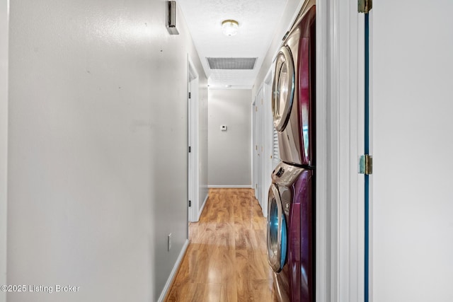 268 Cobb Rd, Eminence, KY 40019 - laundry room featuring light wood-style flooring, baseboards, visible vents, stacked washer and dryer, and laundry area