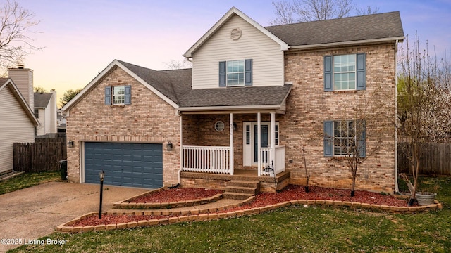 4316 Arwine Ct, Louisville, KY 40245 - traditional home featuring a garage, brick siding, a porch, and concrete driveway