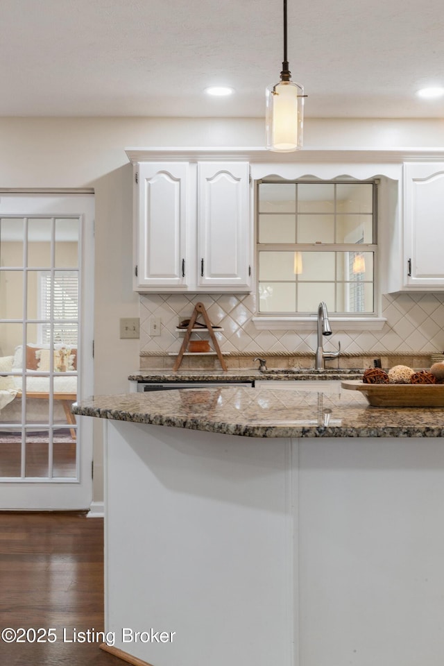 4316 Arwine Ct, Louisville, KY 40245 - kitchen with a sink, backsplash, white cabinets, and hanging light fixtures