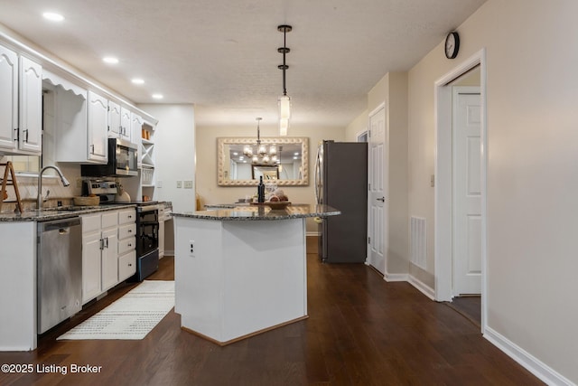 4316 Arwine Ct, Louisville, KY 40245 - kitchen featuring white cabinetry, appliances with stainless steel finishes, a center island, and dark stone counters