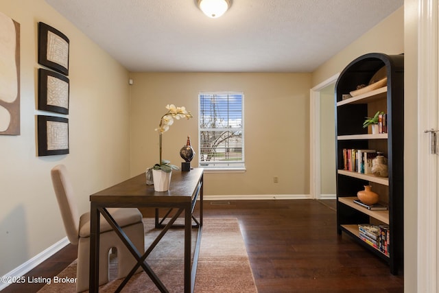 4316 Arwine Ct, Louisville, KY 40245 - home office with baseboards, dark wood-style flooring, and a textured ceiling