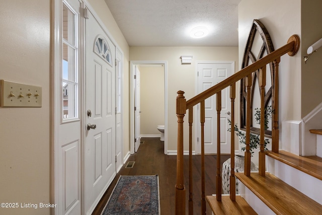 4316 Arwine Ct, Louisville, KY 40245 - entrance foyer featuring dark wood-style floors, a textured ceiling, stairs, and baseboards
