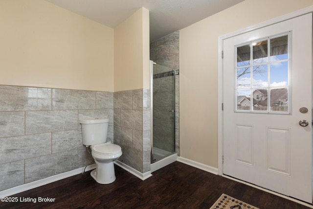 4316 Arwine Ct, Louisville, KY 40245 - full bath featuring a shower stall, toilet, tile walls, and wood finished floors