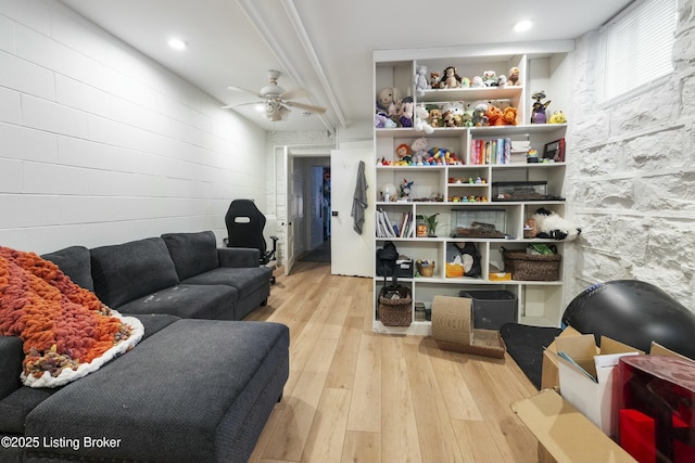 living area with ceiling fan and hardwood / wood-style flooring