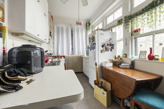 sunroom / solarium with a sink and radiator