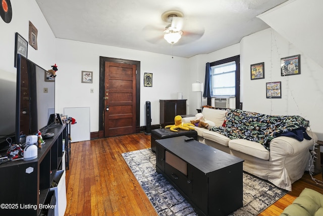 living room with cooling unit, a ceiling fan, and hardwood / wood-style floors